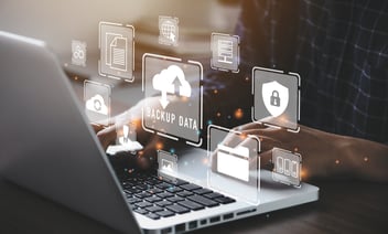 Person sitting at a laptop viewing software features