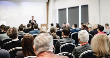 Conference audience watching a presenter