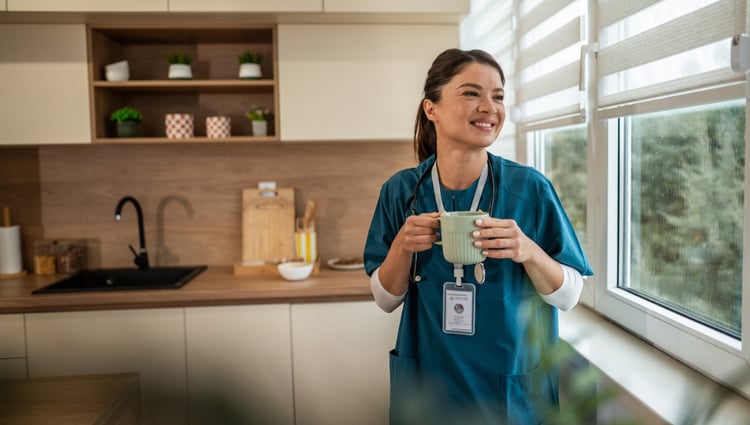 female doctor with a cup of tea staring out the window