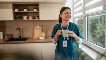 female doctor with a cup of tea staring out the window