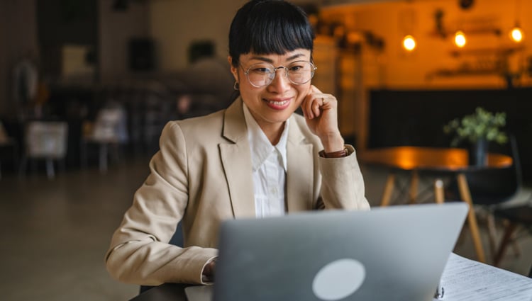 woman on laptop smiling