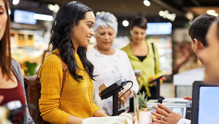 woman using a card payment machine at the supermarket