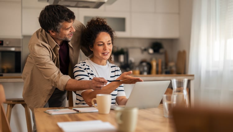 woman and man collaborating on a laptop