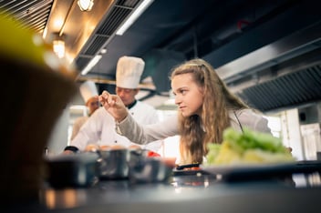 Apprentice chef preparing a dish
