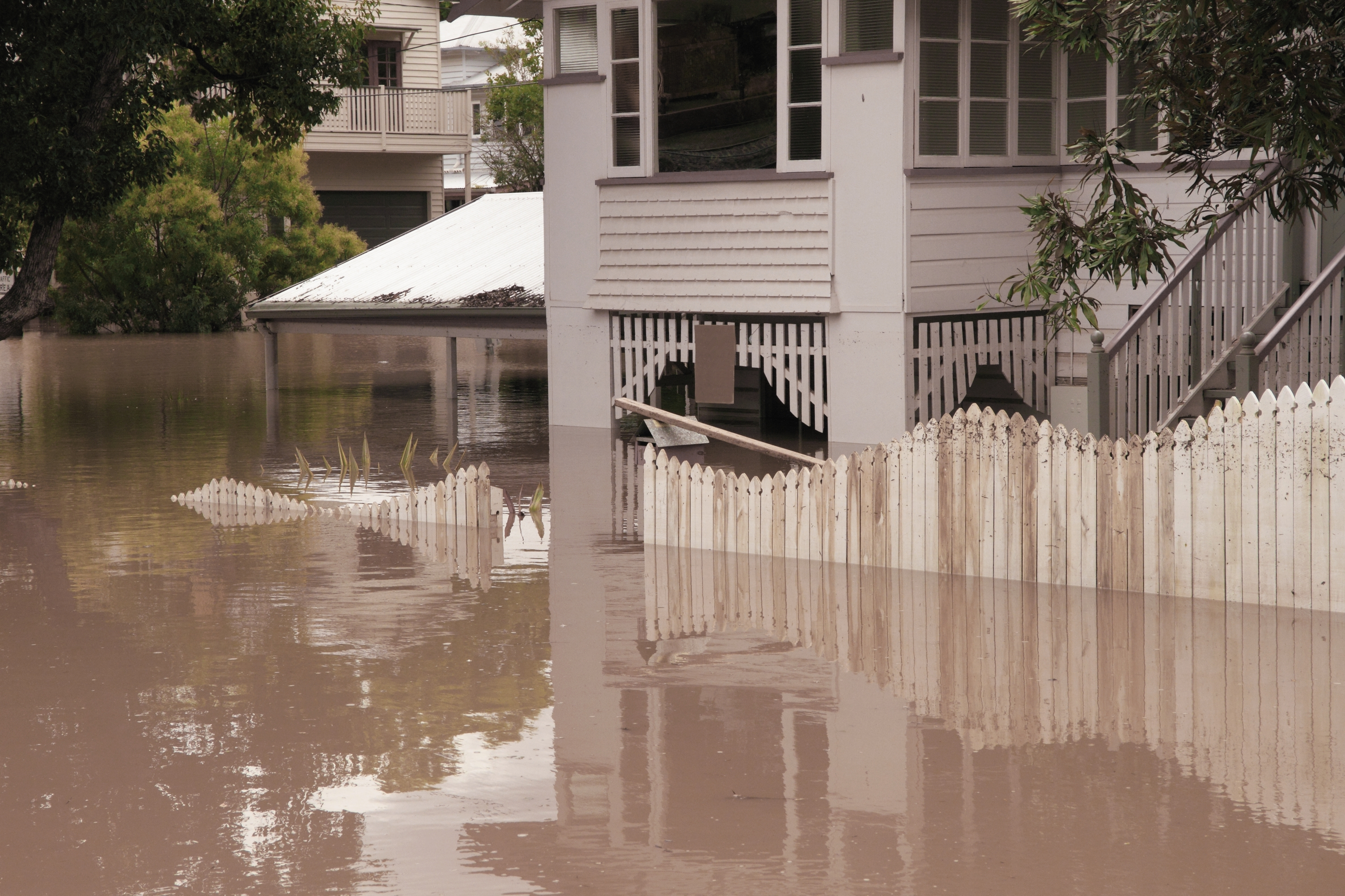 Front of house and gate showing high flood waters