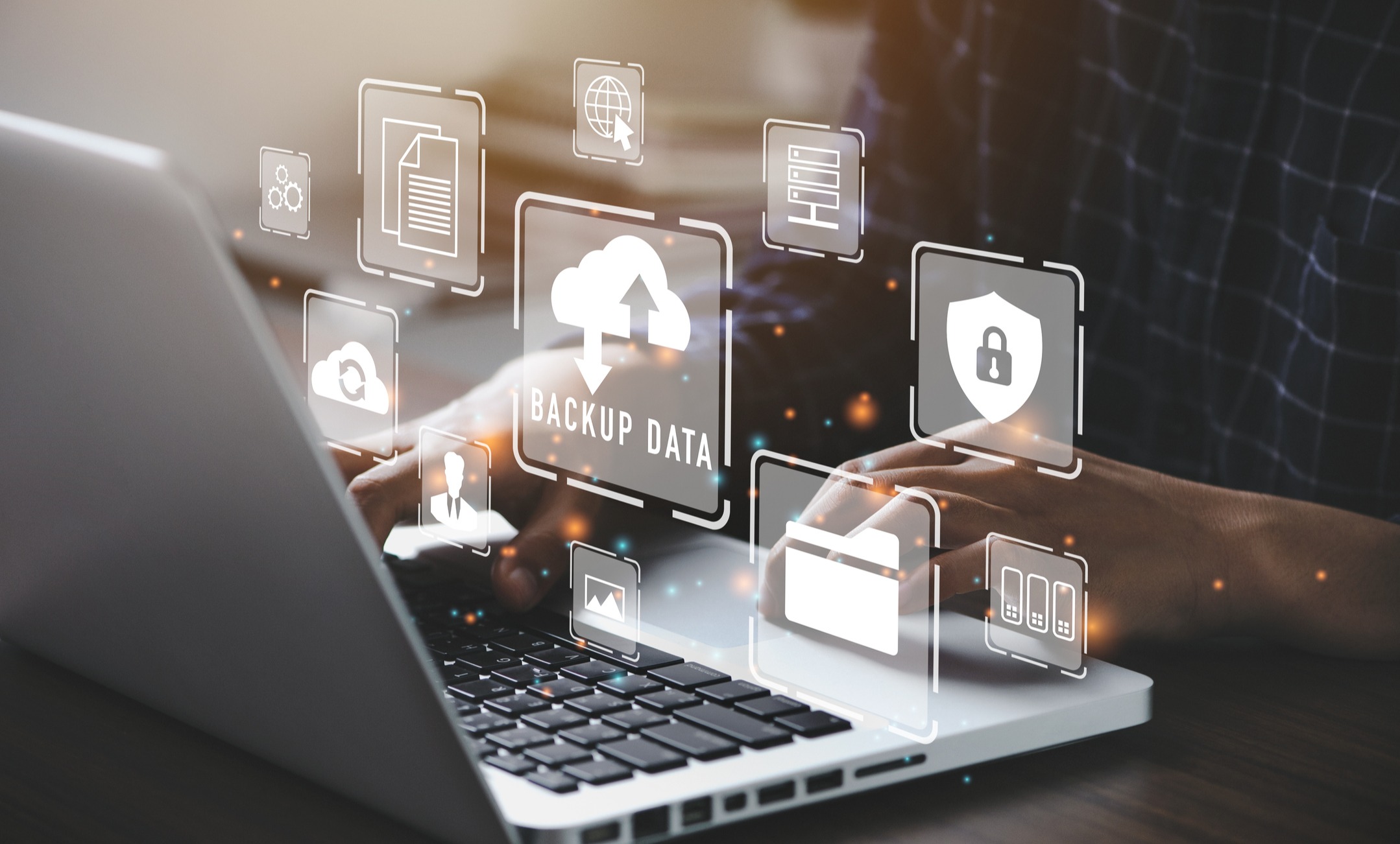 Person sitting at a laptop viewing software features