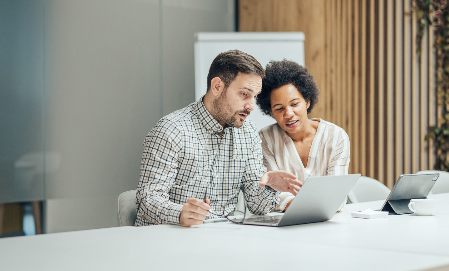 Man and woman reviewing information on a laptop
