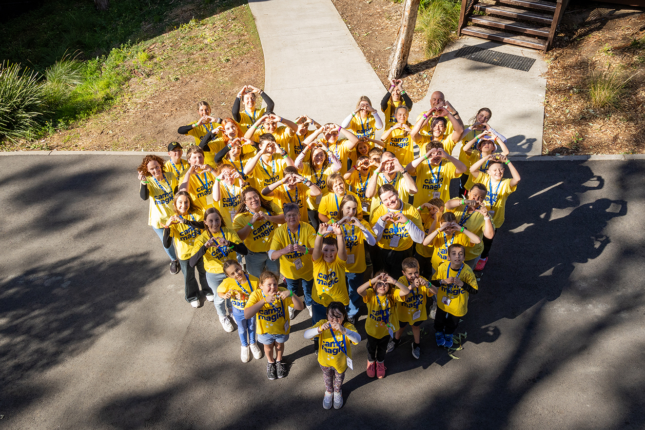 Feel The Magic Camp Magic kids gathered in the shape of a heart