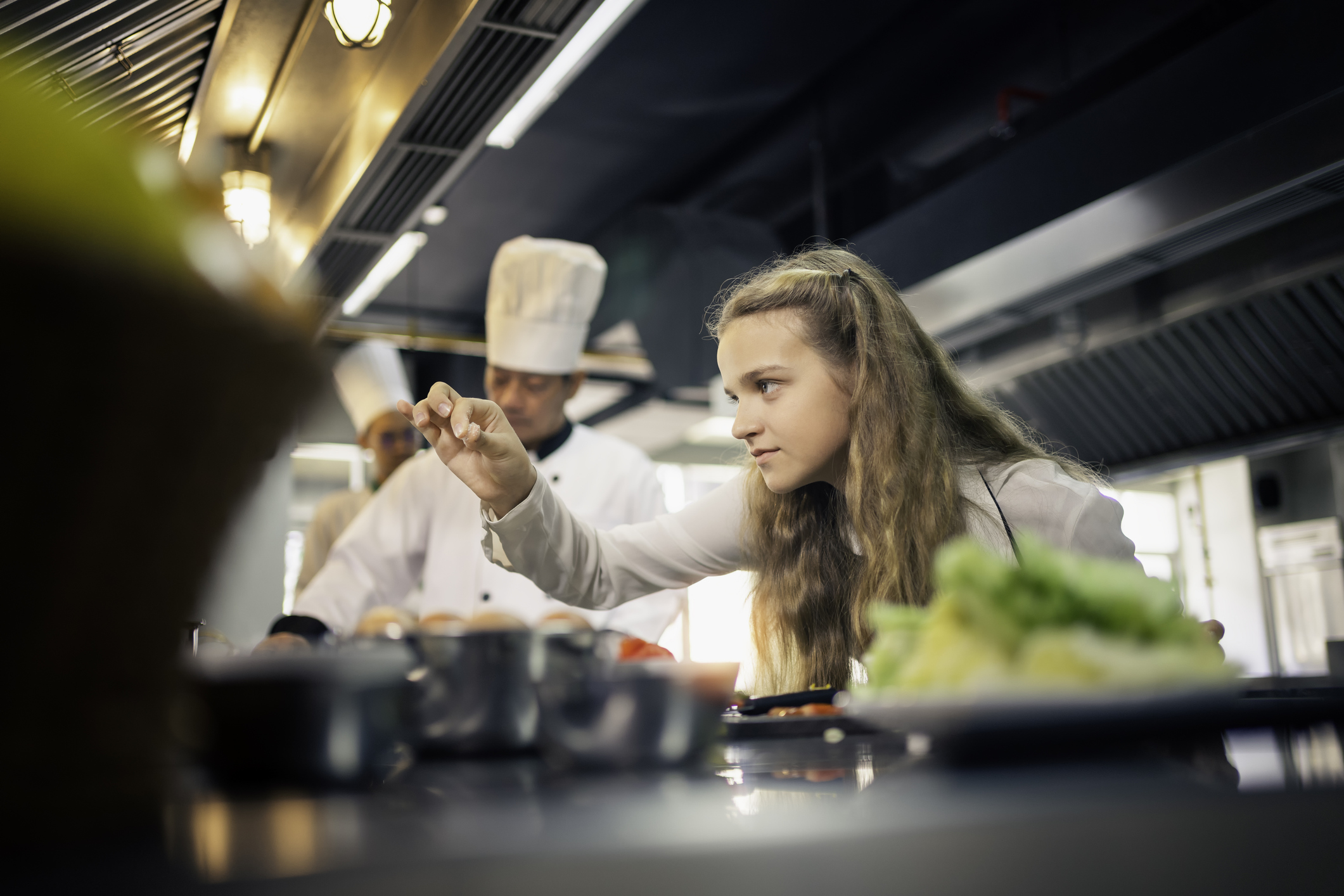 Apprentice chef preparing a dish